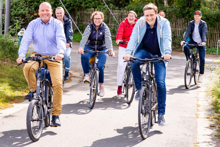 Politiker fahren mit Bürgern auf einer Wahlkampf-Fahrradtour